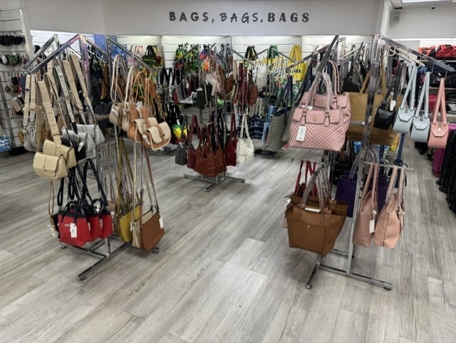 Handbag displays showing a variety of designer purses, totes, and fashionable bags